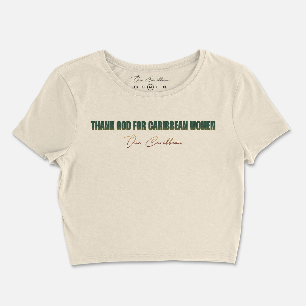 A beige crop top with the text 'THANK GOD FOR CARIBBEAN WOMEN' printed across the front.